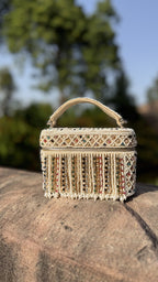 Front view of the Adira Pearl and Bead Statement Bag, displaying its dense white pearl pattern and structured top handle.