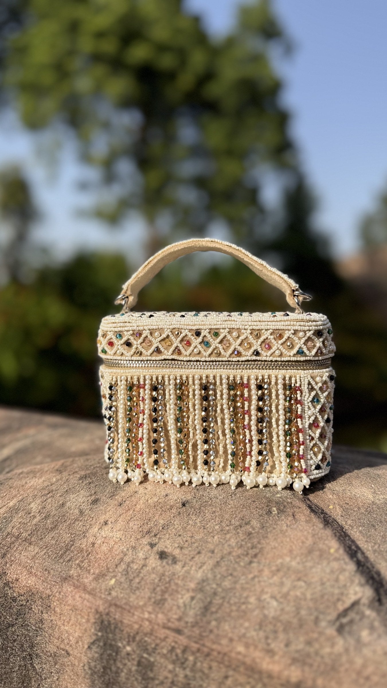 Front view of the Adira Pearl and Bead Statement Bag, displaying its dense white pearl pattern and structured top handle.