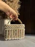 Close-up of the metal clasp attachment and the textured bead pattern on the side panel.