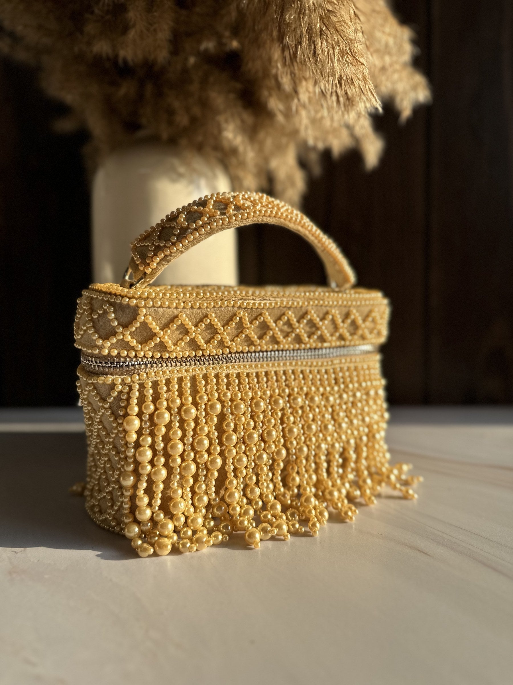 The Adira pearl bag resting on a marble surface, displaying its reflective jewelry-like qualities.