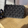 Side angle view of the Ahana bag showcasing its lightweight profile and strap connections.