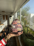 Almond clutch styled handheld to showcase its comfortable organic grip.