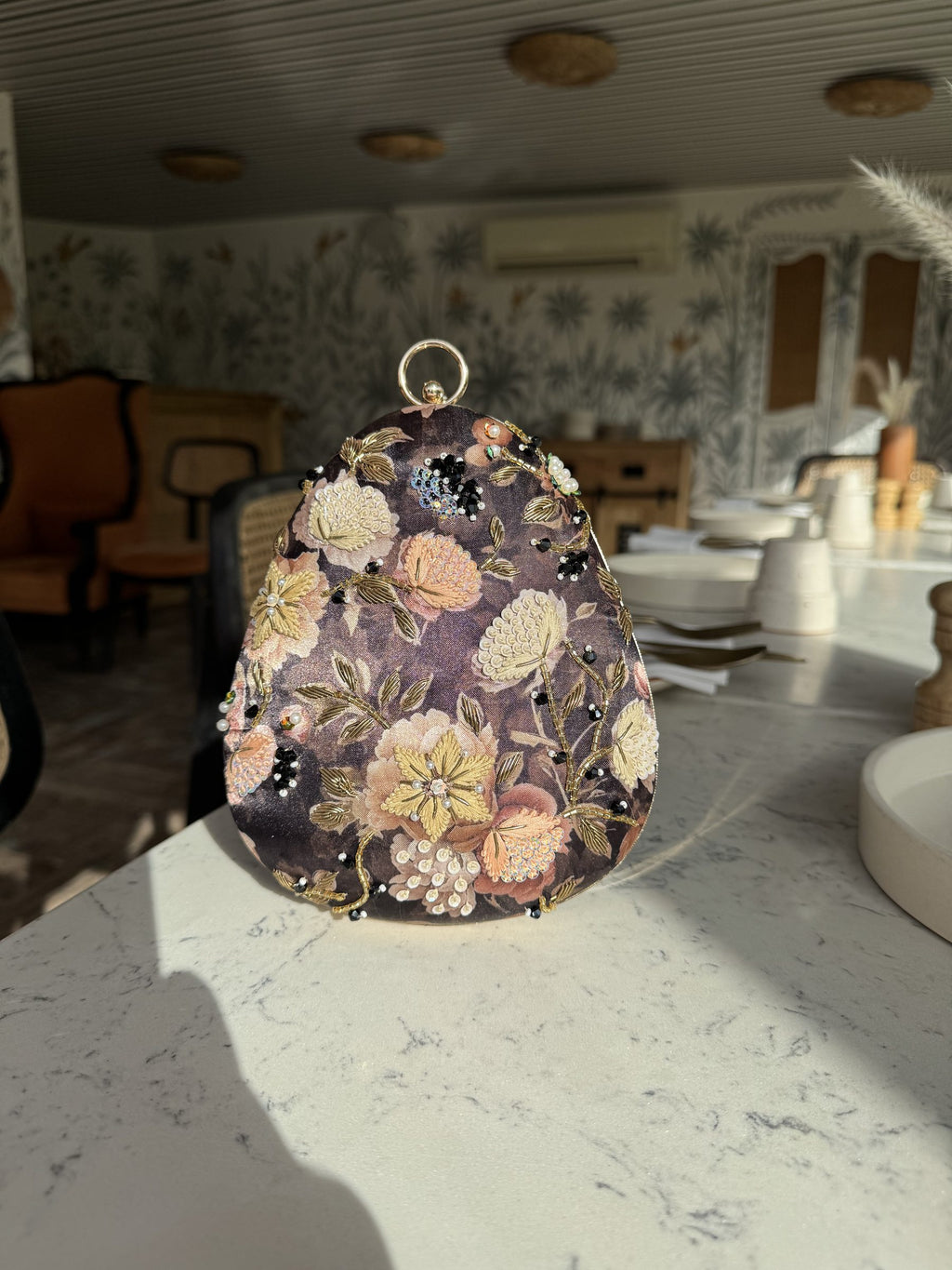 The clutch styled with a wristlet option for casual evening carry.
