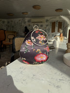 Almond clutch styled in a daylight studio setting showing realistic colors.