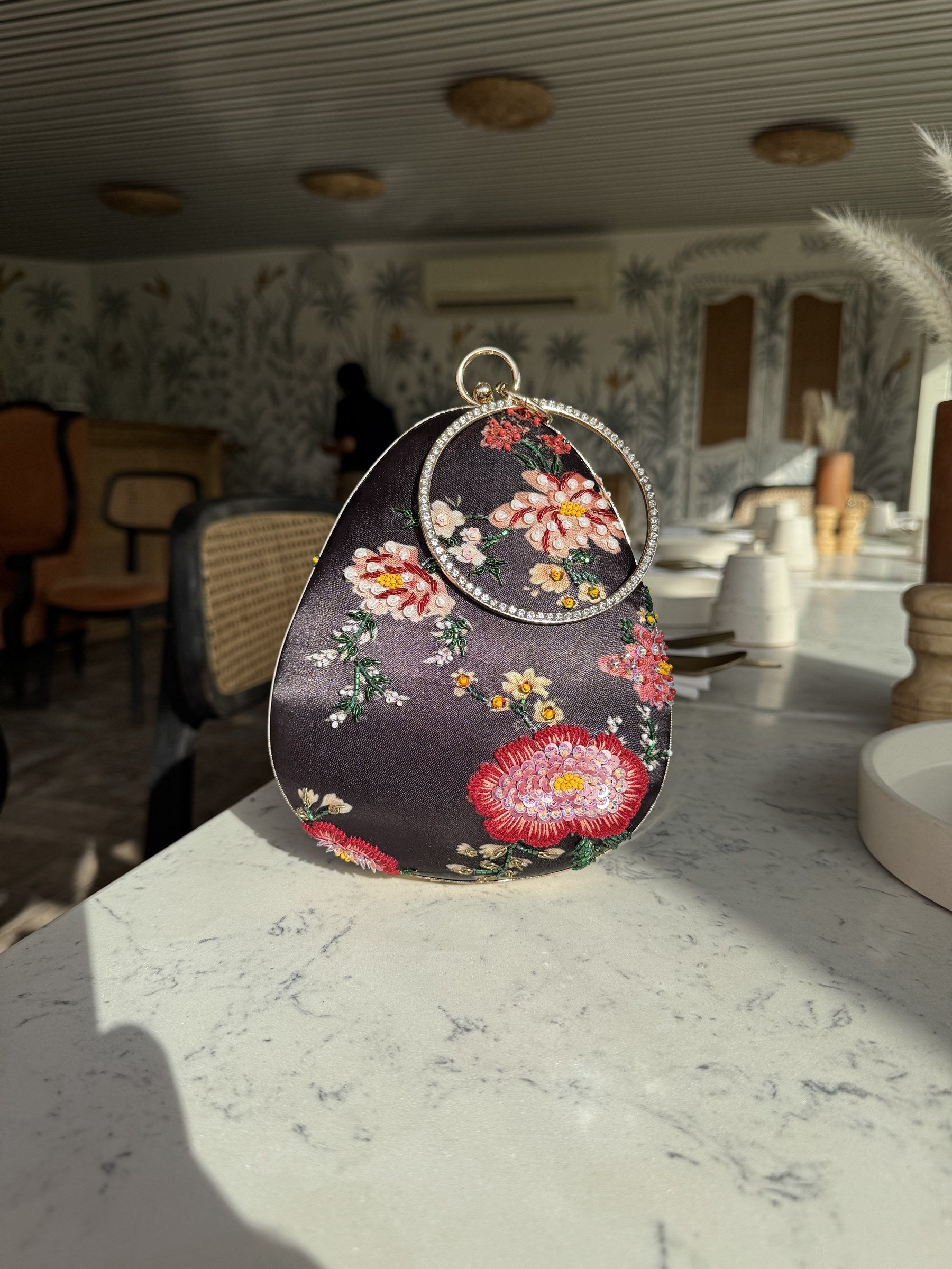 Almond clutch styled in a daylight studio setting showing realistic colors.