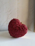 The Amour heart bag open, displaying the soft red satin lining and compact main compartment.