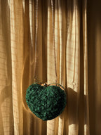 The Amour Beaded Clutch displayed with romantic decor, highlighting its Valentine theme.