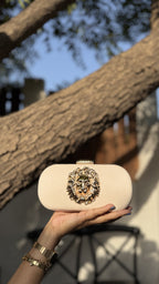 Aurelia clutch in jewel blue, highlighting its rich metallic sheen.