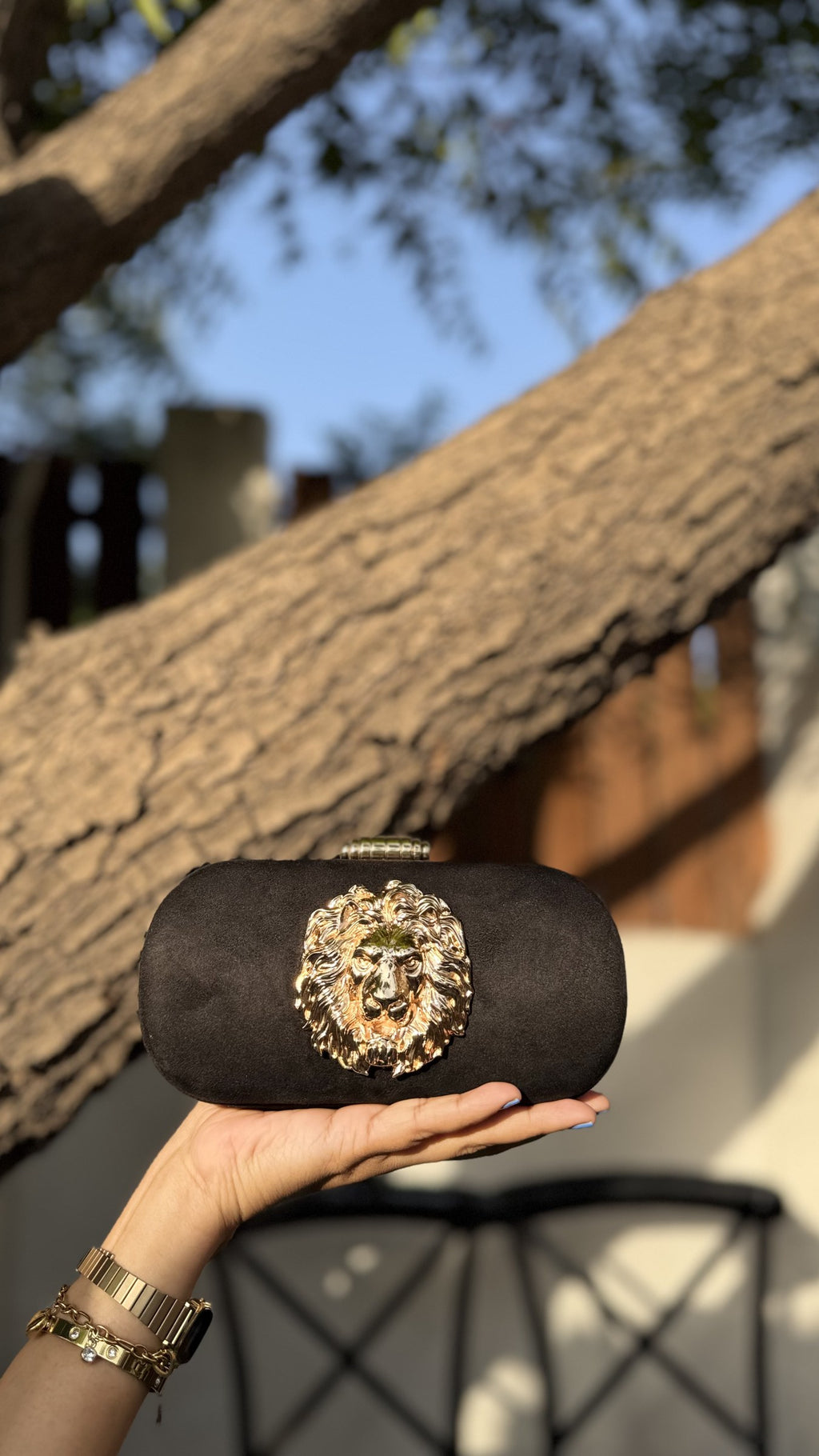 Aurelia clutch in rose pink, demonstrating a soft metallic glow.