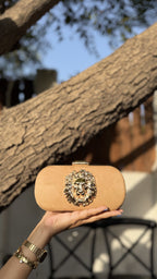 Aurelia clutch in emerald green, displaying its deep metallic finish.