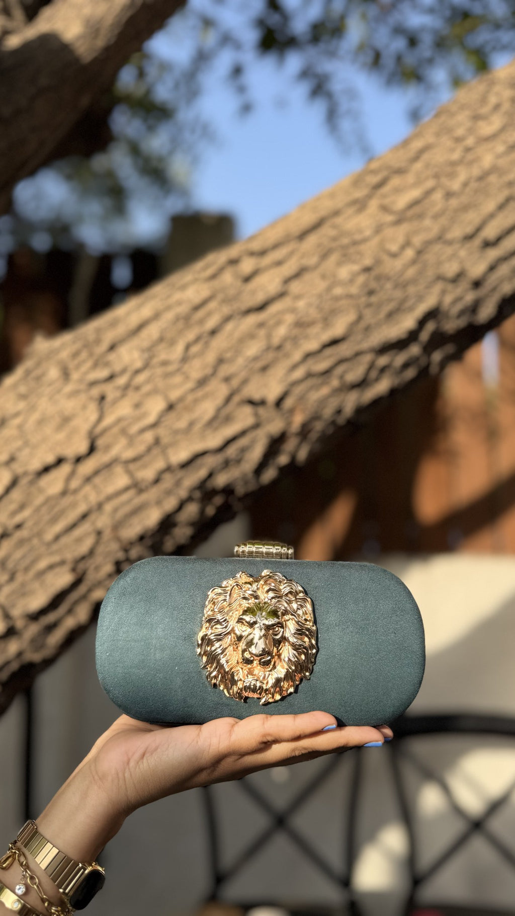 Rear view of the Aurelia clutch showing the consistent metallic fabric coverage on the back.