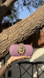 Open view of the Aurelia handbag showing its internal fabric lining and clasp hinge.