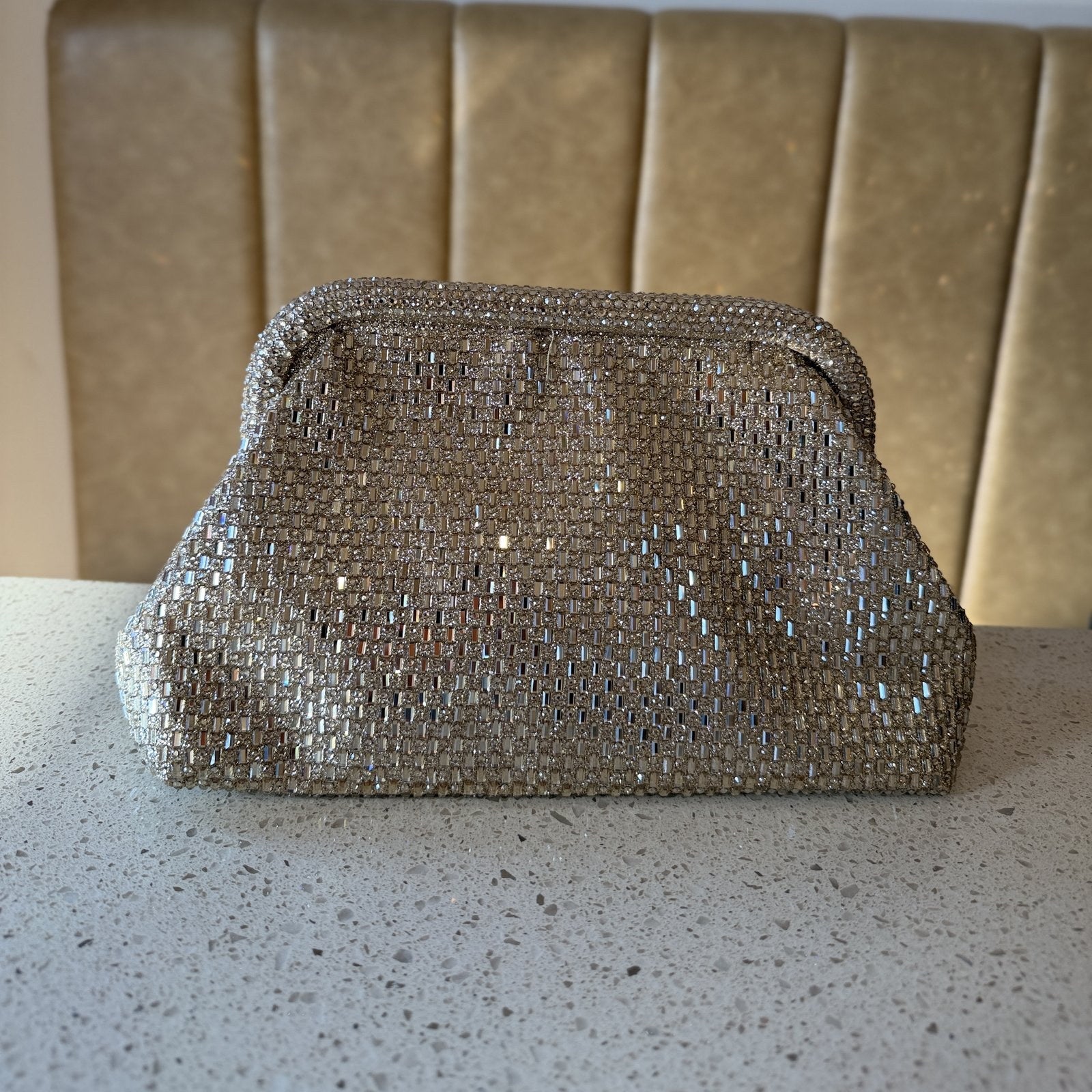 Close-up of the gold clasp mechanism on the Aurelle statement bag.