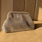 The interior of the Aurelle clutch showing the spacious satin-lined compartment.