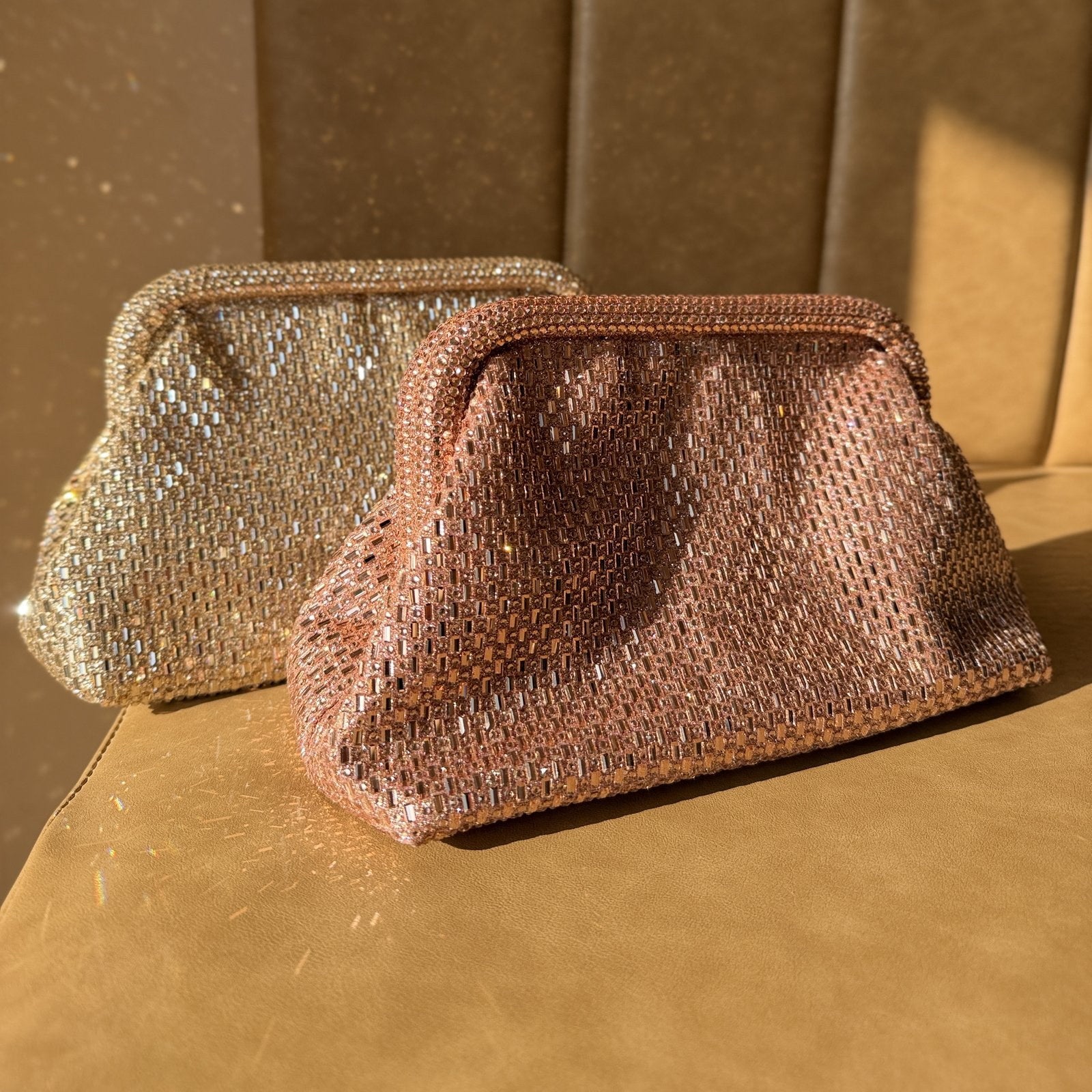 The Aurelle clutch open, displaying fit capacity for an iPhone Pro Max and accessories.