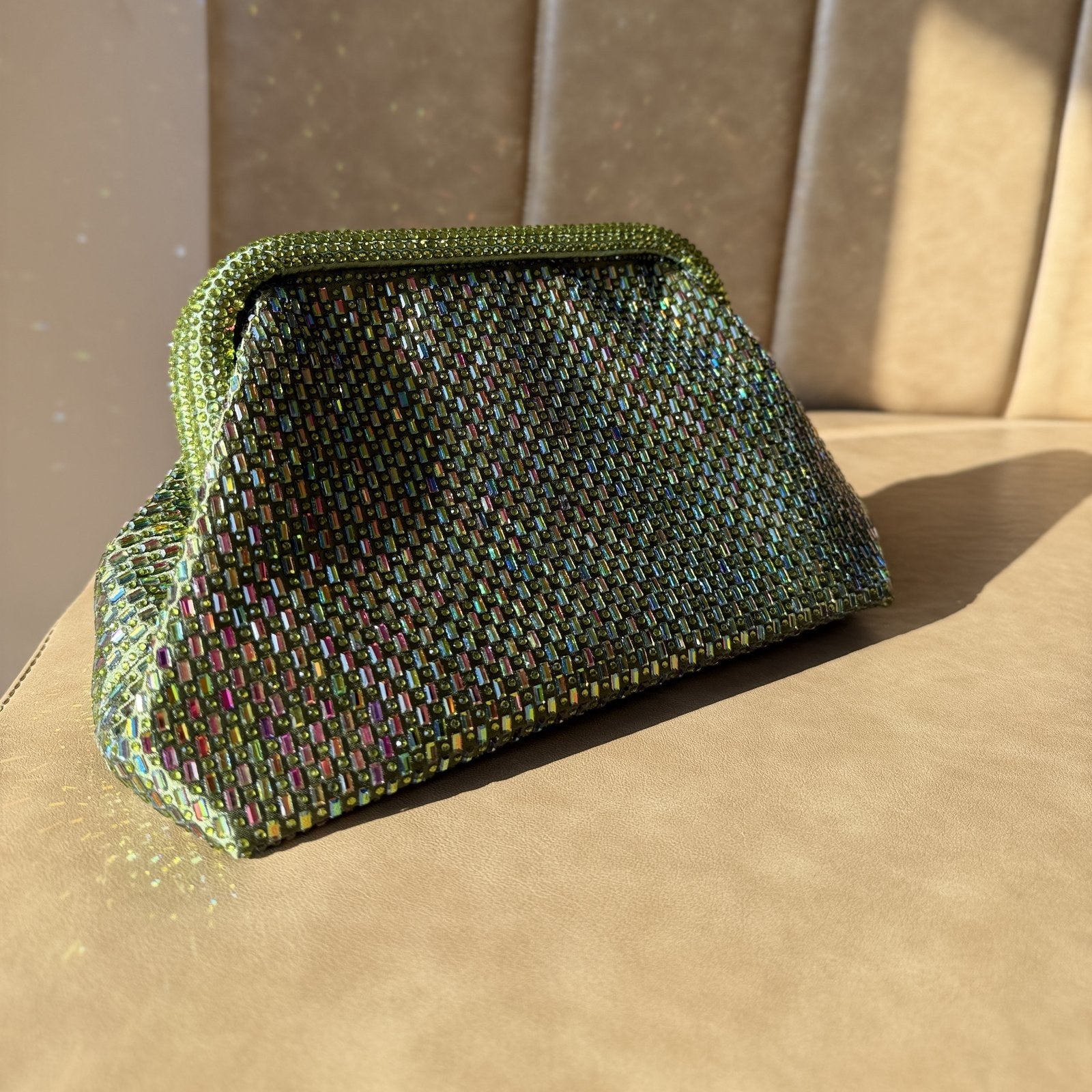 A model carrying the Aurelle clutch handheld, illustrating its elegant handheld proportion.