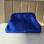 The Aurelle bag hanging on a display stand, highlighting its high-end hardware finish.