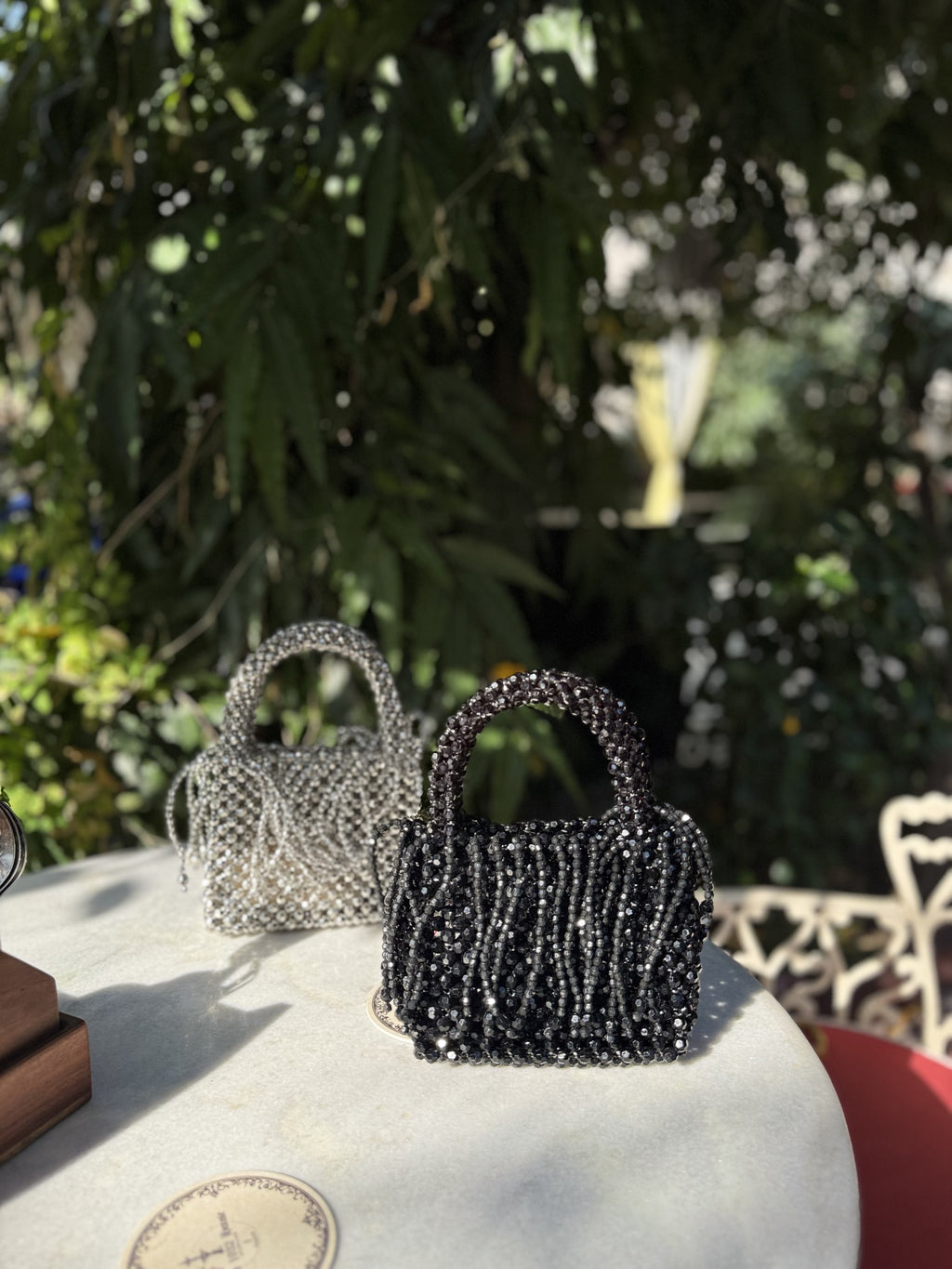 Front view of the Beadazzle Beaded Box Bag, displaying its dense multicolored beading and square shape.
