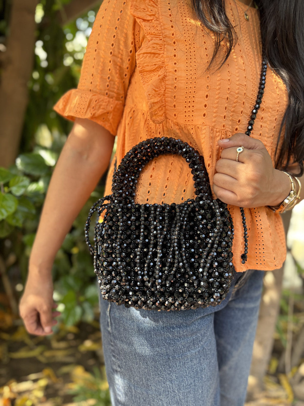 The Beadazzle Bag shown with its detachable satin pouch resting next to it.