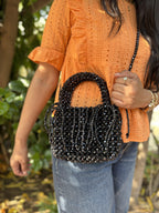 The Beadazzle Bag shown with its detachable satin pouch resting next to it.