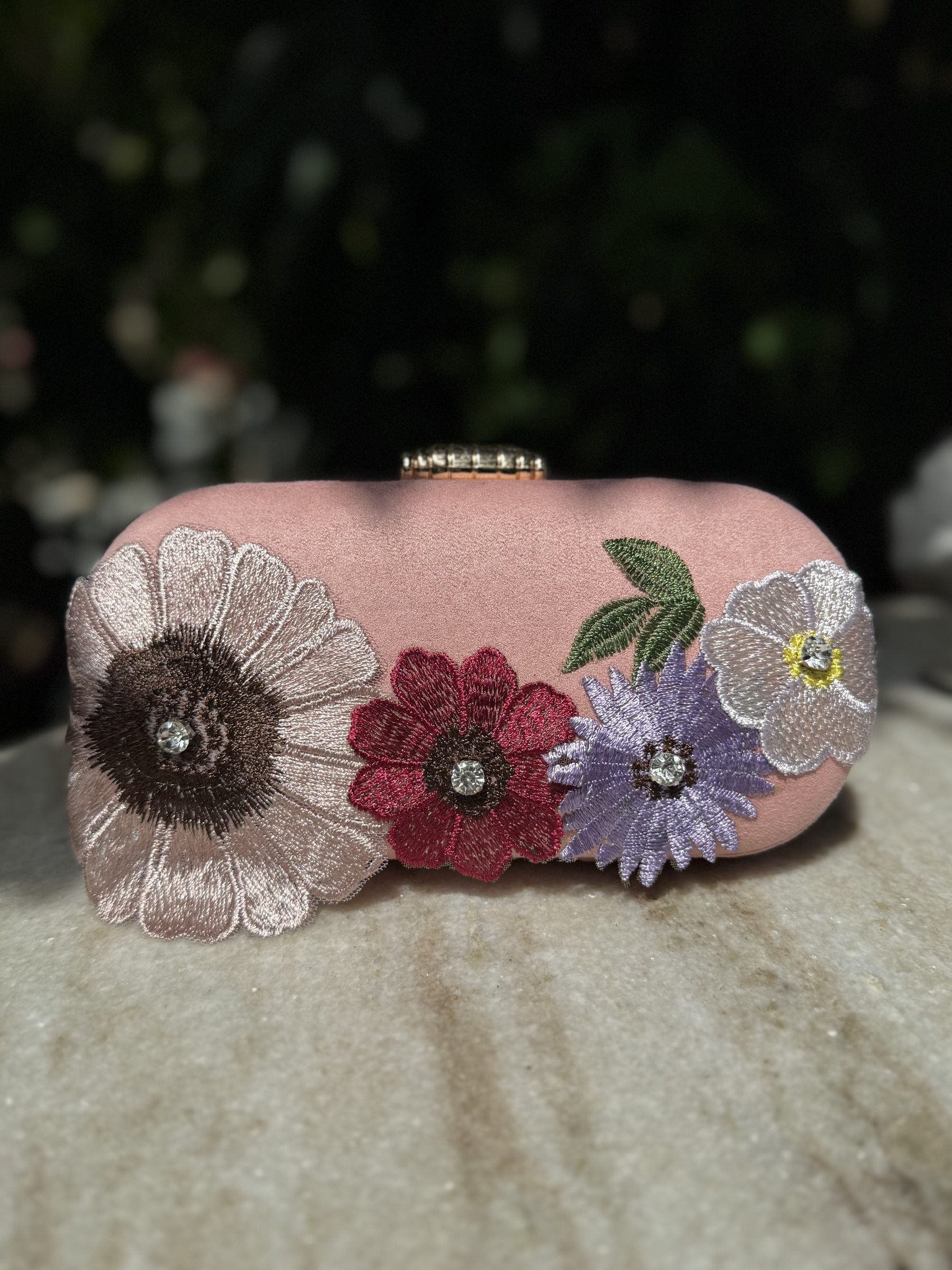 Open view of the Bloom Box handbag displaying its interior lining and smartphone storage capacity.