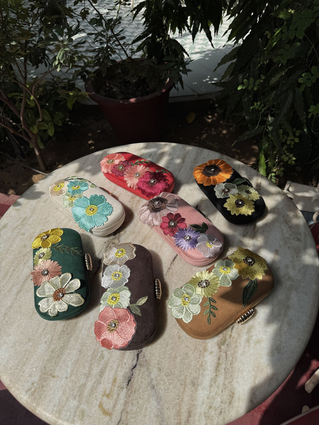 Lifestyle layout of the Bloom Box clutch next to traditional wedding accessories and jewelry.