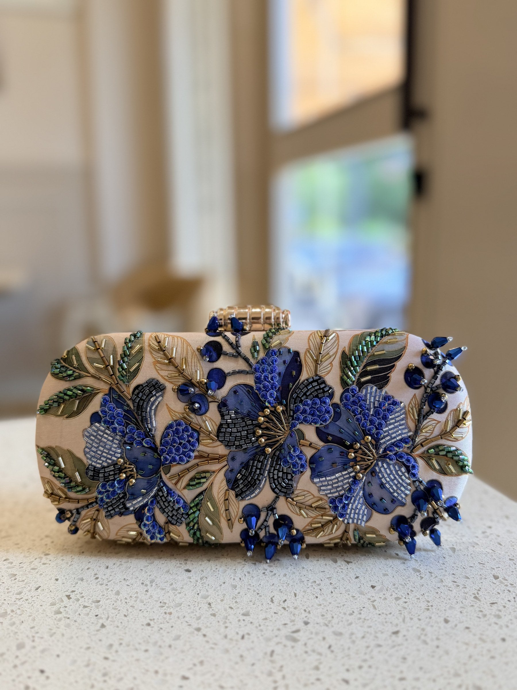 Capsule clutch styled handheld showcasing its comfortable rounded size.