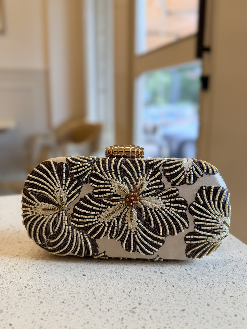 The clutch styled with a cocktail outfit showing styling coordinates.