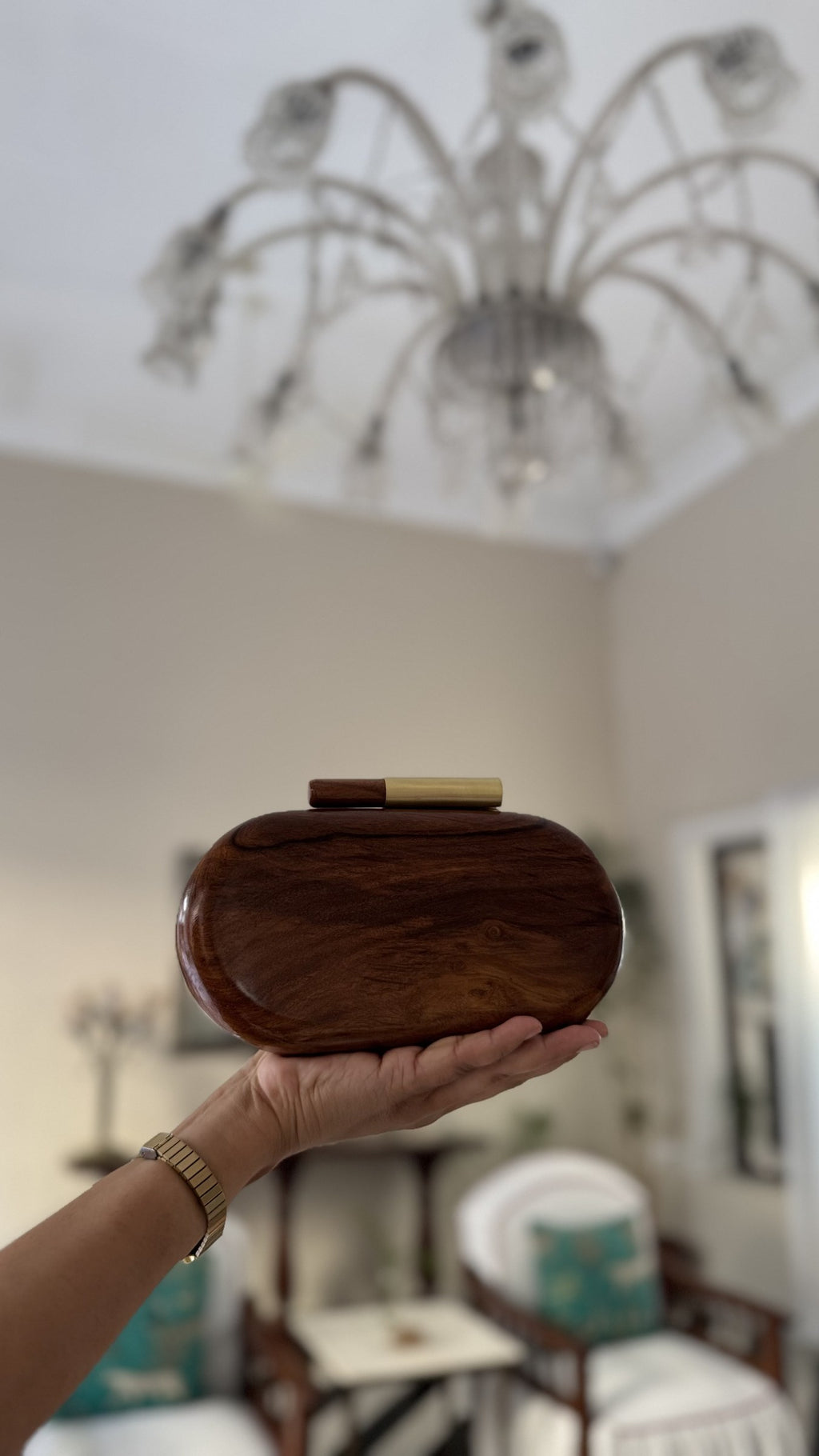 Detail view highlighting the rich natural wood grain variations across the capsule surface.