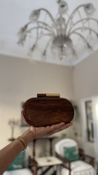 Detail view highlighting the rich natural wood grain variations across the capsule surface.