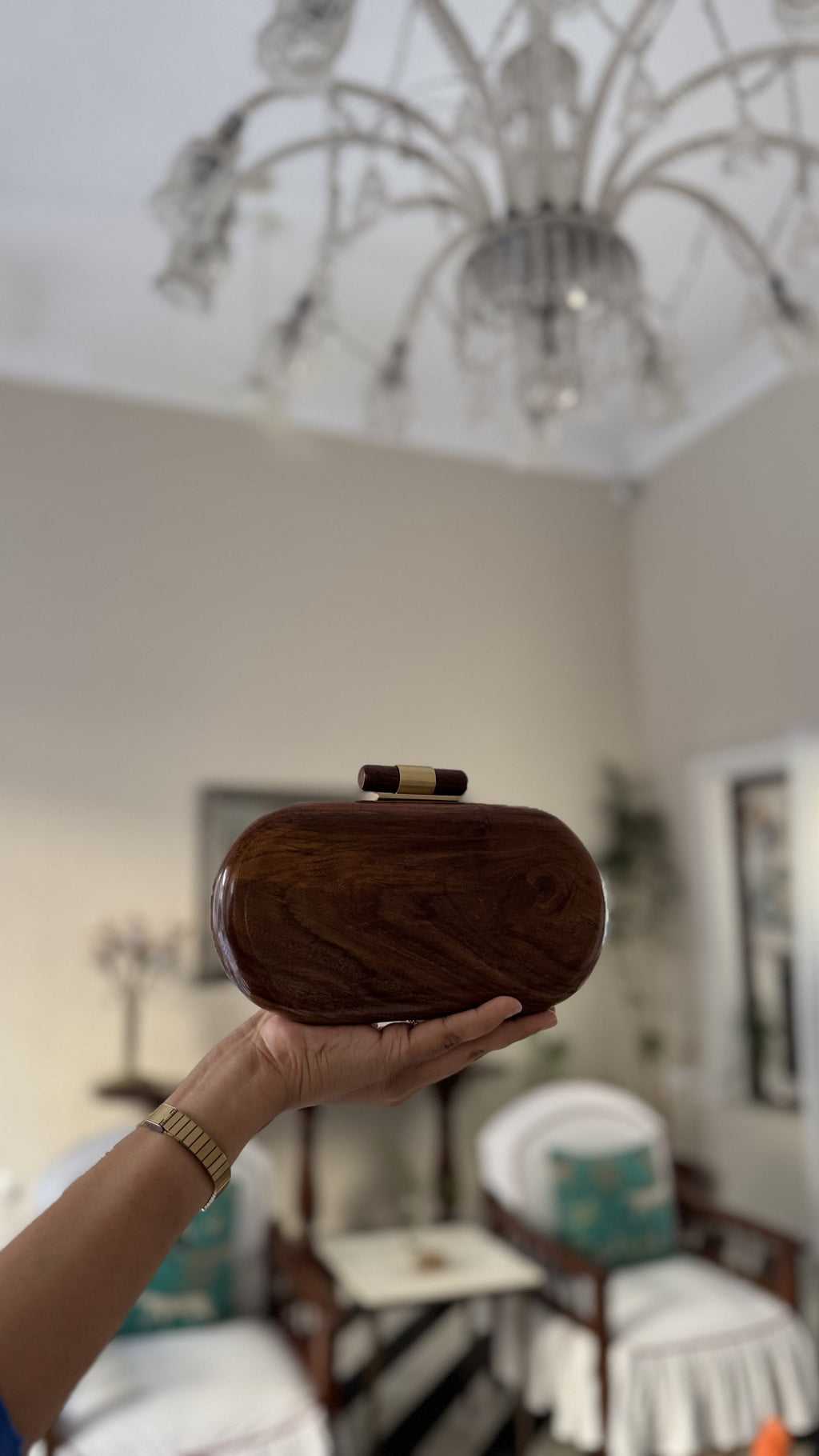 Wooden clutch shown alongside jewelry and wedding coordinates to illustrate styling options.