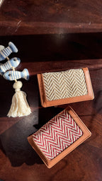 Cardo slim wallet in tan leather showing cards partially inserted into the slots.