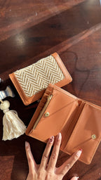 Cardo wallet held in hand to showcase its compact size and practical daily use appeal.
