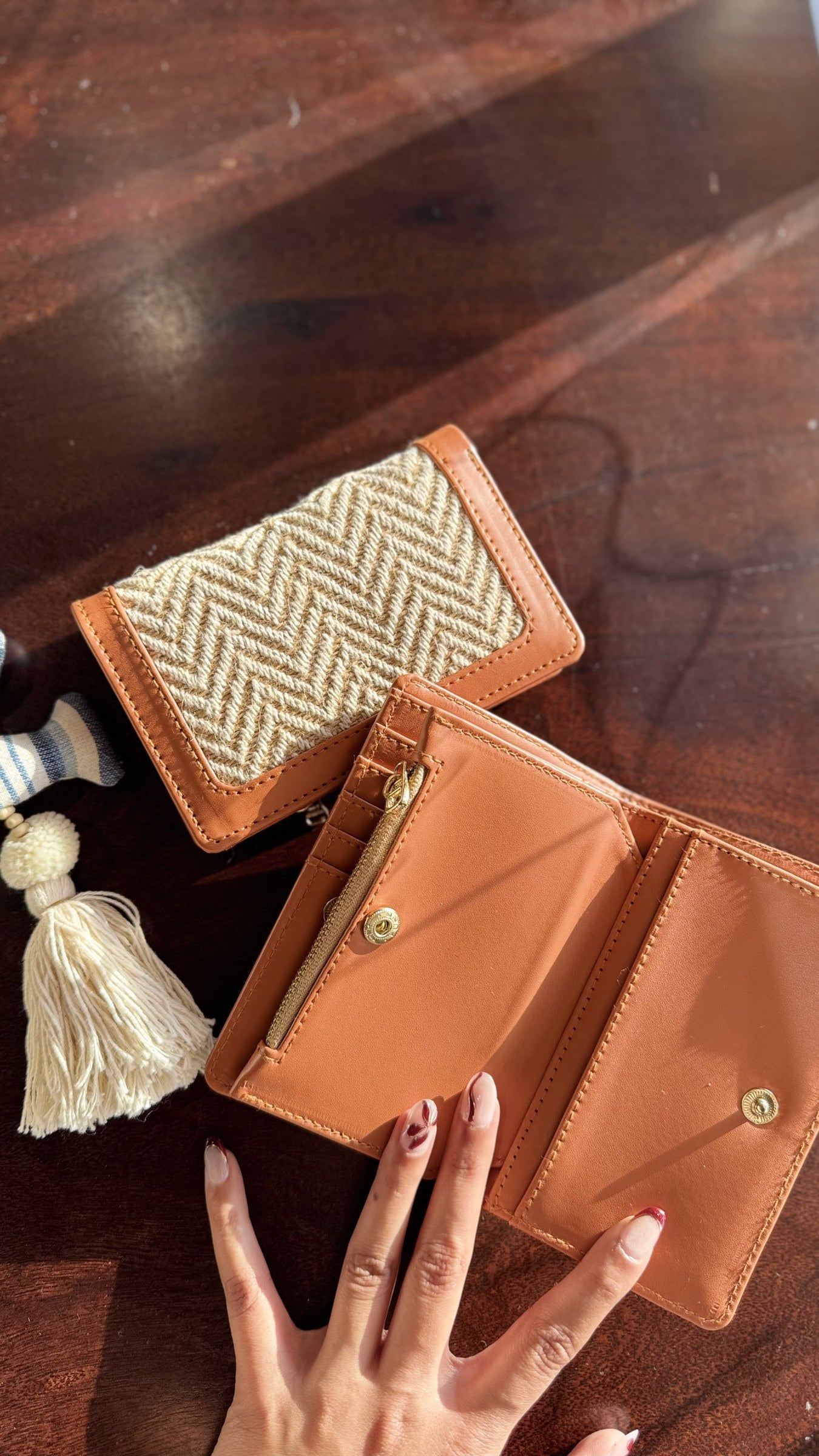 Cardo wallet held in hand to showcase its compact size and practical daily use appeal.