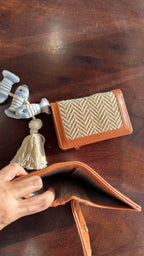 Cardo minimalist tan leather wallet shown alongside keys and everyday essentials.
