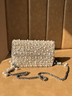Side angle of the Celebration Capsule clutch showing its slim profile and gold clasp.