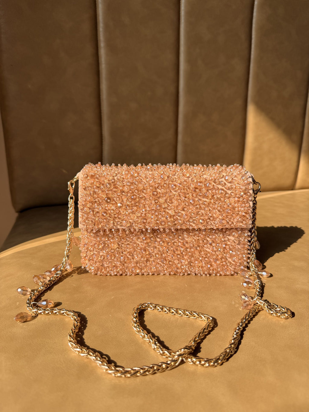 Top view of the Celebration Capsule showing the clasp mechanism and fabric texture.