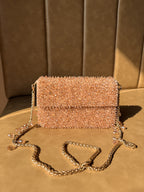 Top view of the Celebration Capsule showing the clasp mechanism and fabric texture.