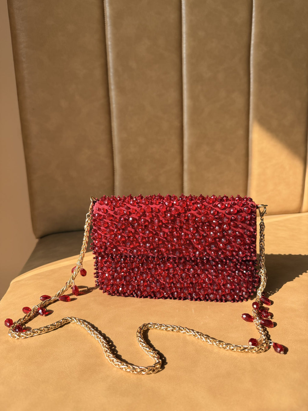 Rear panel of the Celebration Capsule clutch, displaying the uniform pearl embellishment.