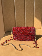 Rear panel of the Celebration Capsule clutch, displaying the uniform pearl embellishment.