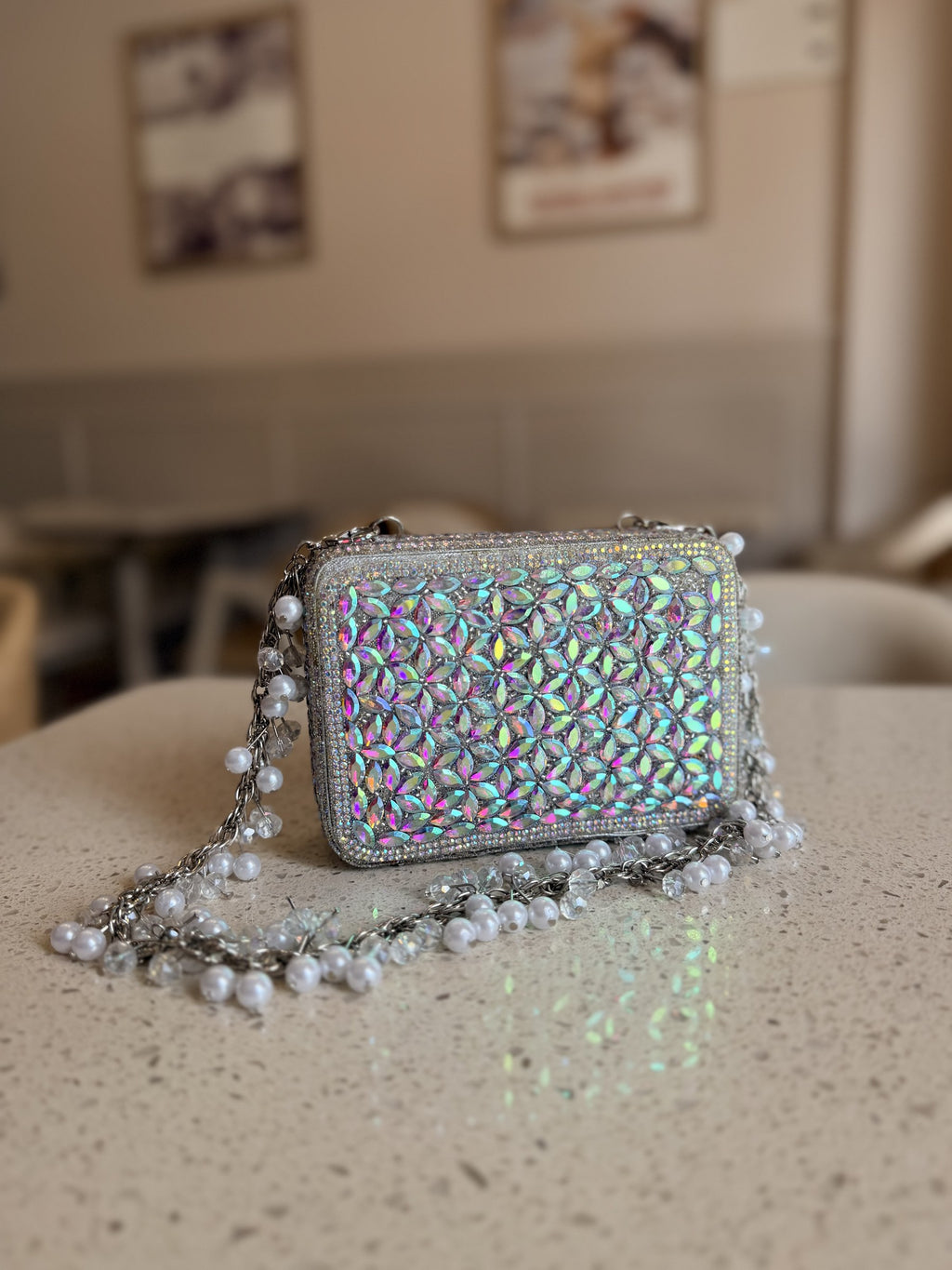 Champagne Crush mini bag displaying its sparkling champagne beadwork and gold-tone wrist chain.