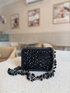 Detailed close-up of the champagne sequins and glass beads hand-sewn onto the fabric base.