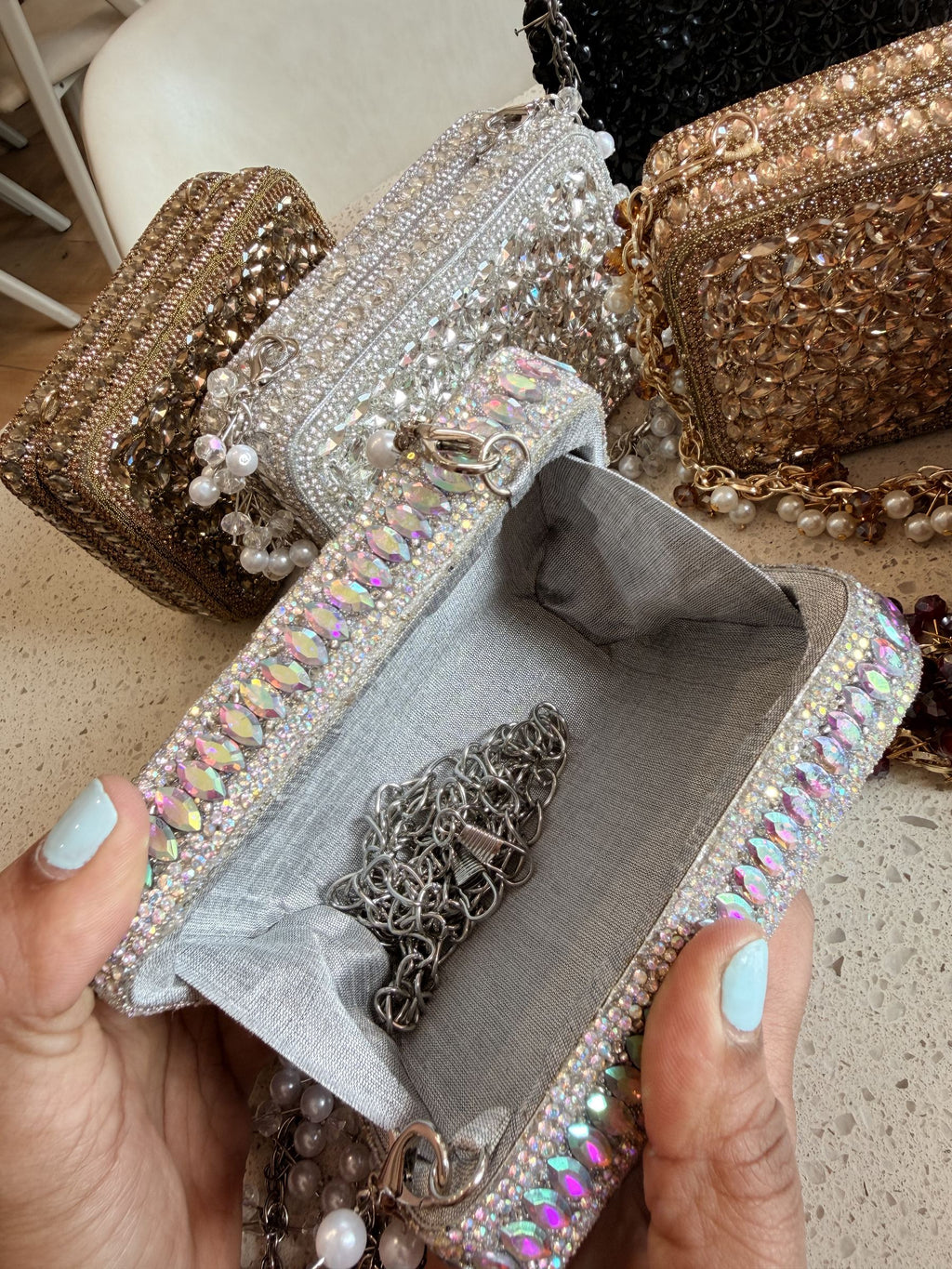Flat lay of the Champagne Crush mini showing the gold-tone sling chain attached.