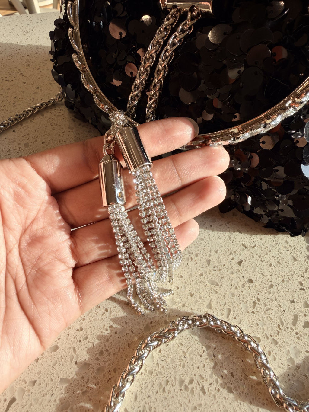 Model wearing the Disco Dust bag as a shoulder baguette with the sling chain.