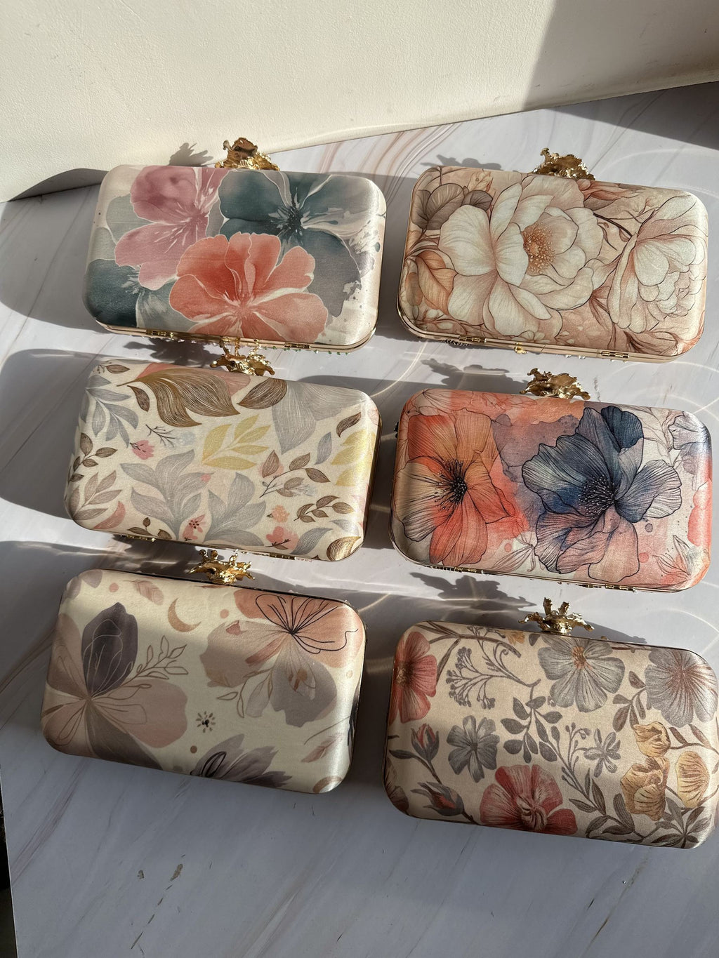 Eight-by-Four digital print clutch showing its multicolored abstract art panel and gold clasp.