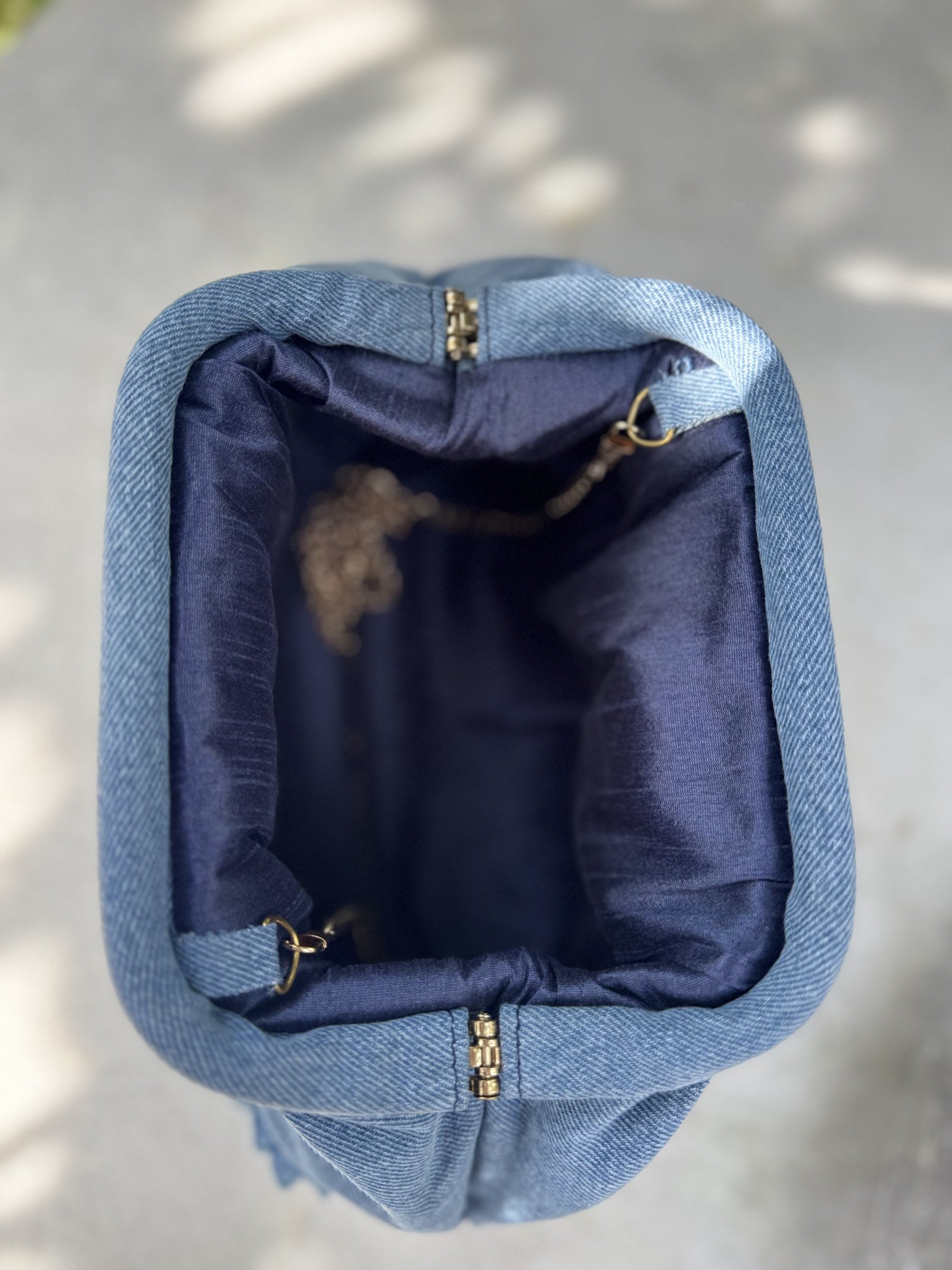 Top-down view of the gathered closure and inner lining of the floral bag.