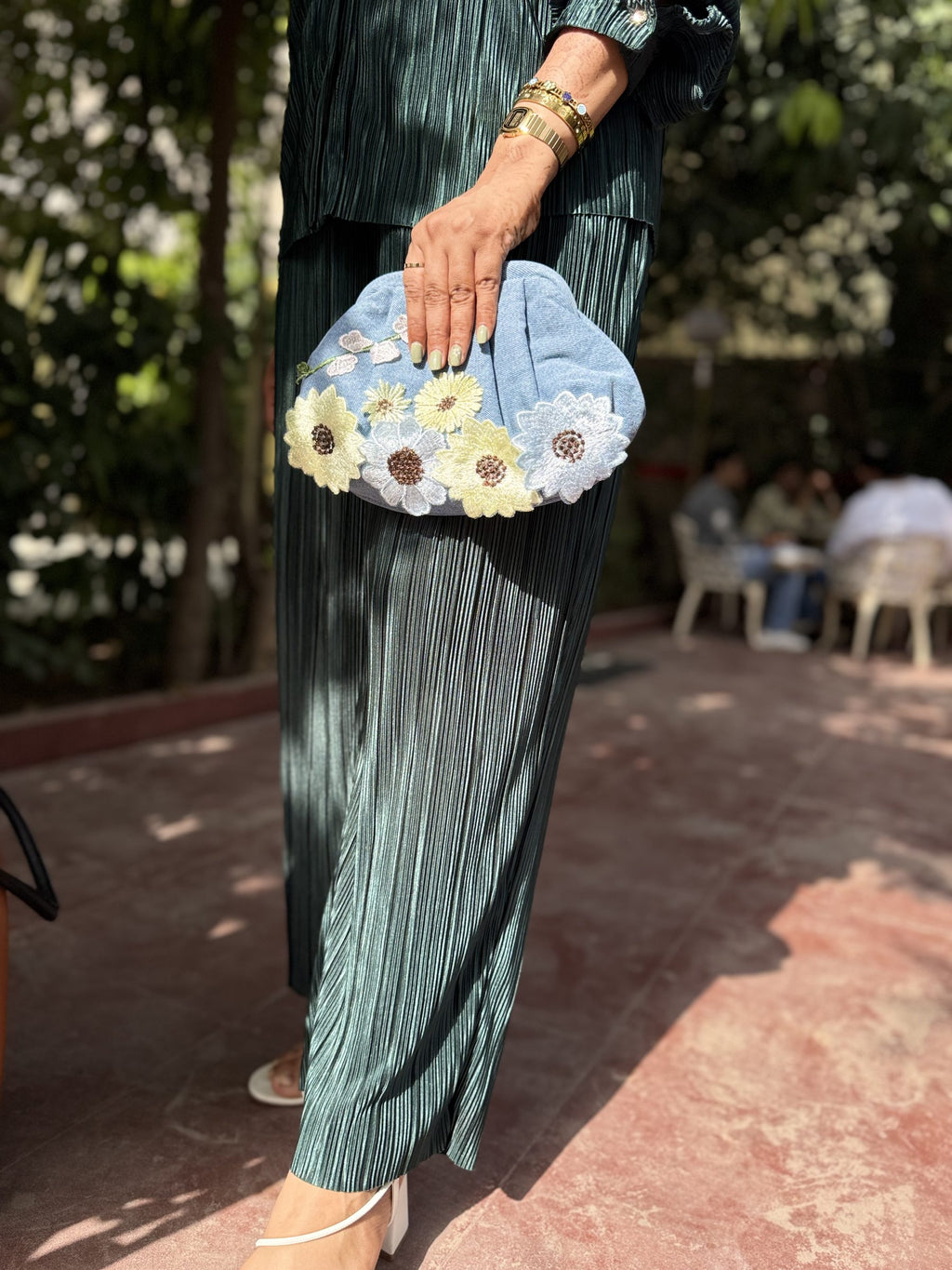 Model hand-carrying the bag to showcase its soft, pillowy handle feel.
