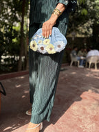 Model hand-carrying the bag to showcase its soft, pillowy handle feel.