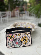 Front view of the Funky Fix Bag showing its vibrant chili pepper appliqué and boxy shape.