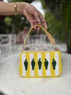 Side panel view of the Funky Fix bag displaying its baguette width and stitching.
